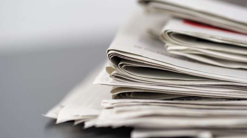 A closeup shot of several newspapers stacked on top of each other